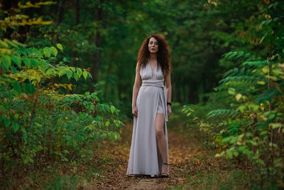 Woman standing in a forest