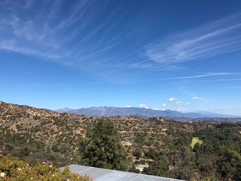 Scenic view of mountains against blue sky