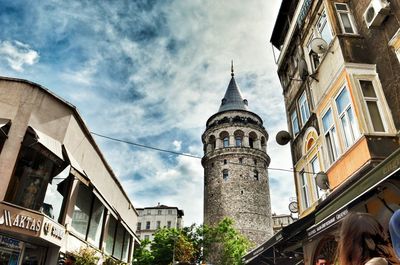 Low angle view of clock tower against sky in city