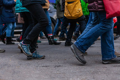 Low section of people walking on road