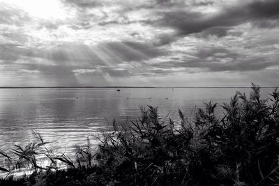 Scenic view of sea against cloudy sky