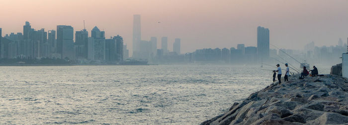 Panoramic view of buildings on city during winter against sky