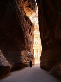 Silhouette man standing in cave