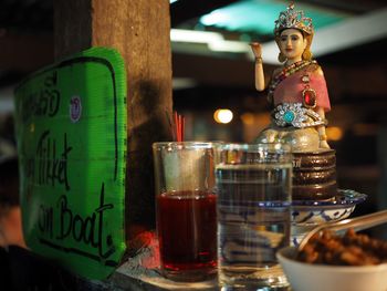 Figurine by food and drink on table