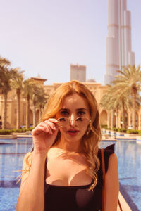 Portrait of young woman in swimming pool