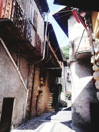 Staircase amidst houses against sky