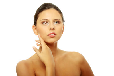 Portrait of beautiful young woman against white background