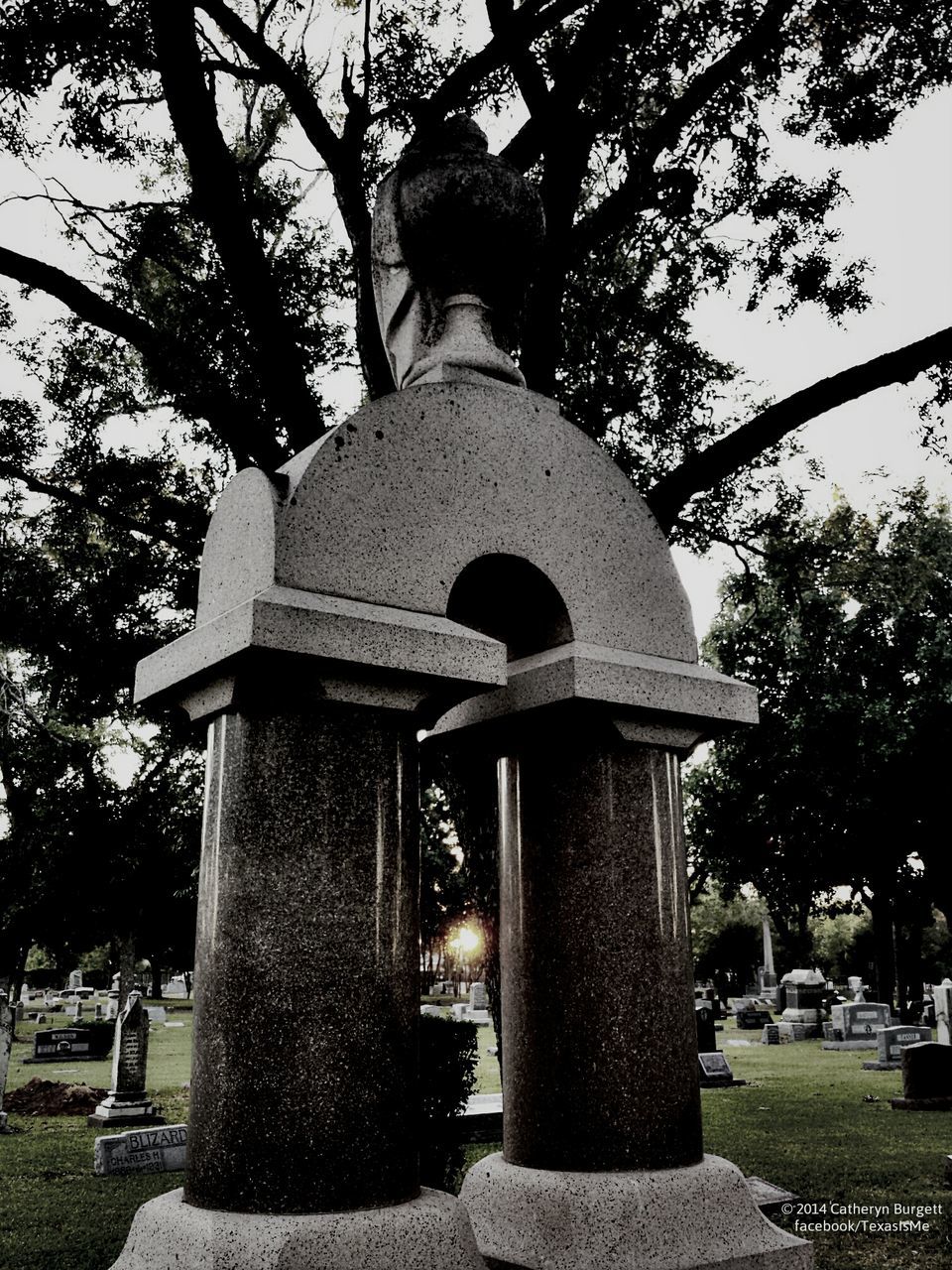 tree, religion, statue, spirituality, sculpture, art and craft, human representation, place of worship, built structure, art, architecture, creativity, building exterior, cemetery, cross, park - man made space, low angle view