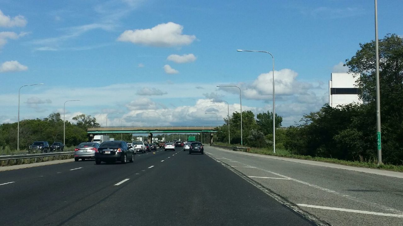 road, car, transportation, land vehicle, cloud - sky, sky, tree, mode of transport, highway, the way forward, day, street, outdoors, no people, city, architecture, building exterior, nature