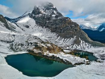 Aerial view of frozen lake against mountain range