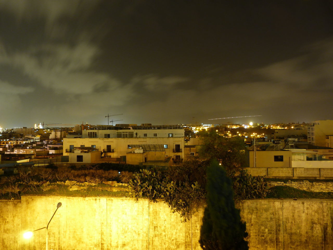 HIGH ANGLE VIEW OF ILLUMINATED BUILDINGS AGAINST SKY