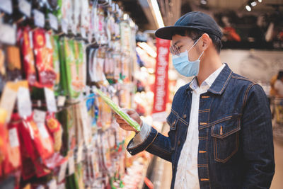 Man wearing mask while standing in super market