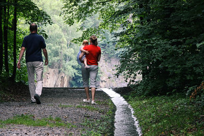 Rear view of family walking at park