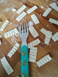 High angle view of food and fork on wooden table