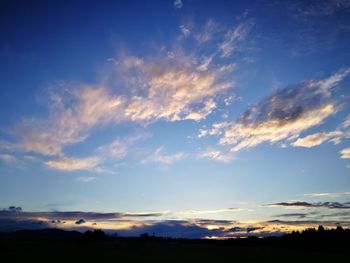 Silhouette of landscape against cloudy sky