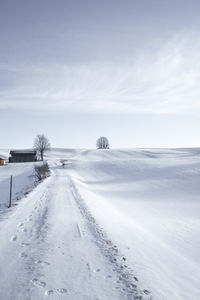 Snow covered road against sky