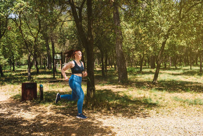 Rear view of woman sitting on field