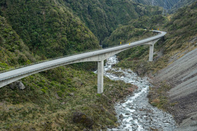 Bridge over road amidst trees in forest