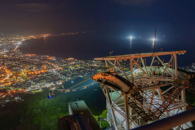 High angle view of illuminated buildings in city at night