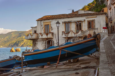 View of boats moored in sea against buildings