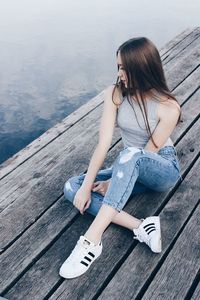 Young woman sitting on wood