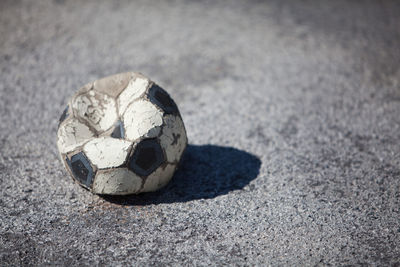 High angle view of damaged soccer ball on street