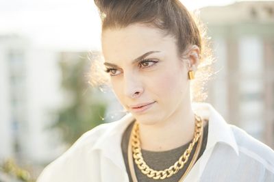 Close-up of woman wearing gold necklace