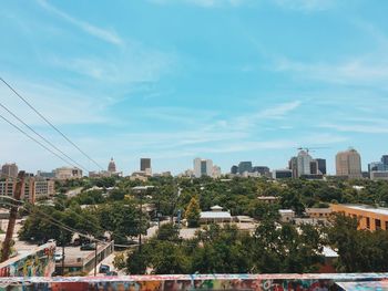 View of cityscape against blue sky