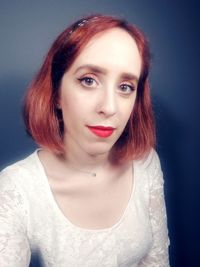 Portrait of beautiful woman against gray background