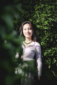 Beautiful women standing among green garden.