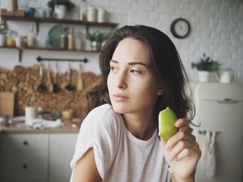 Portrait of young woman holding ice cream