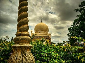 Low angle view of temple against cloudy sky