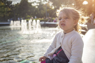 Emotion disgust face. cute grimacing toddler girl in the park