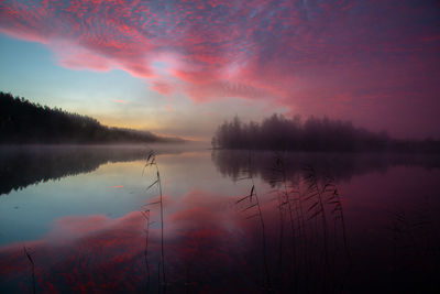 Scenic view of lake against romantic sky at sunset