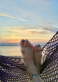 Low section of woman in sea