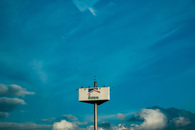 Low angle view of lighthouse against blue sky