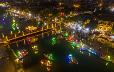 High angle view of illuminated city buildings at night