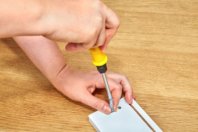 Close-up of man working on wooden table