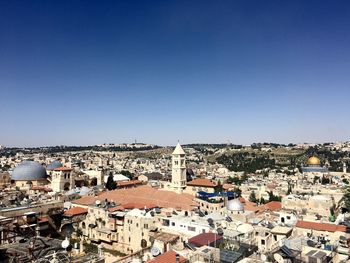 High angle view of town against blue sky