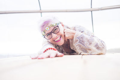 Portrait of smiling woman lying on floor