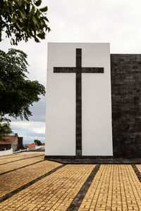 Wall with cross against the sky