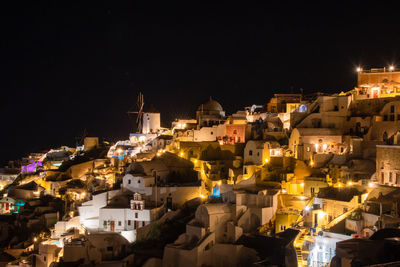 High angle view of illuminated buildings against sky at night