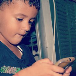 Close-up of boy using mobile phone