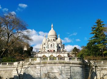 Low angle view of basilique du sacre coeur against blue sky