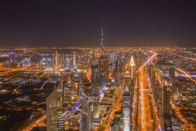 High angle view of illuminated city buildings at night