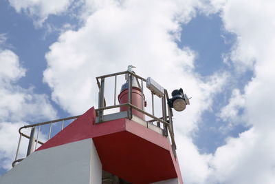 Low angle view of red ship against sky