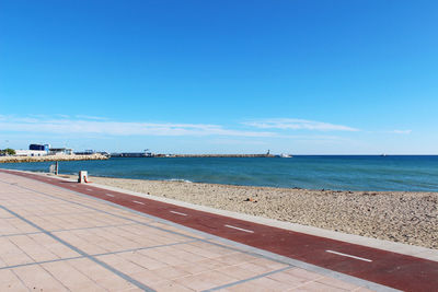 Scenic view of beach against blue sky