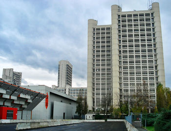 Road amidst buildings in city against sky
