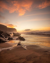 Scenic view of beach against sky during sunset