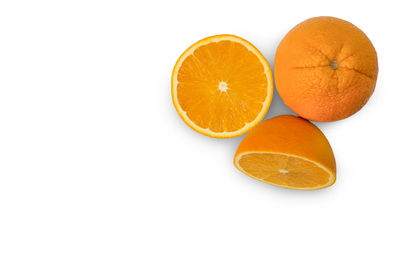 Orange fruits against white background